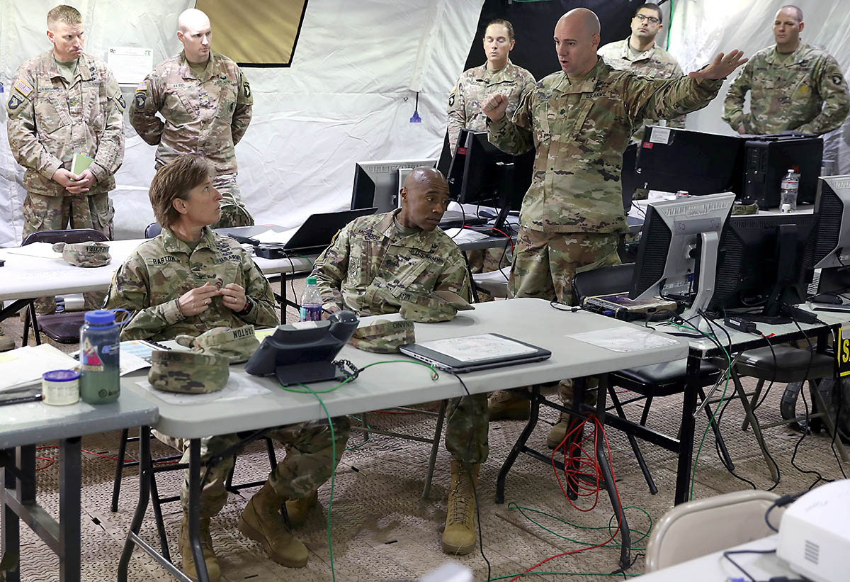 Lieutenant Colonel Paul Bonano (center right), deputy commanding officer for the 101st Sustainment Brigade, 101st Airborne Division (Air Assault), briefs Col. Stephanie Barton, commander of the 101st Sus. Bde., as well as CSM Anthony McAdoo, senior enlisted officer for the brigade, on how set-up and operations during the Tactical Operations Center Exercise have been going, May 13, 2019, on Fort Campbell, Ky. (Staff Sgt. Caitlyn Byrne, 101st Sustainment Brigade Public Affairs)