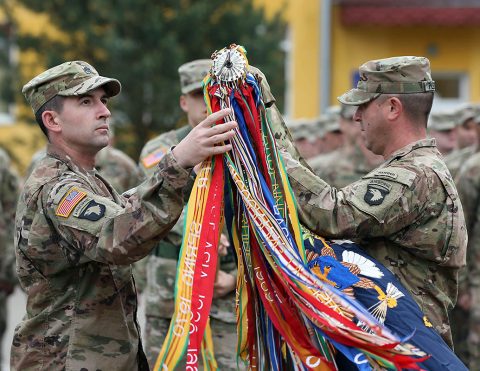 Lt. Col. Robert Tracy, Commander (left), and Command Sgt. Maj. Darren Pleskach, Command Sergeant Major (right), uncased their unit colors during a ceremony here, May 2. (Sgt. Justin Navin, 2nd Brigade Combat Team, 101st Airborne Division (AA) Public Affairs)