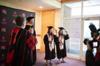 Lidia Yanes Garcia, left, and Claudia Yanes Garcia move their tassels to the left during the ceremony. (APSU)