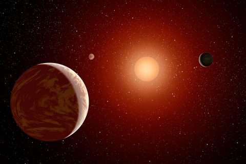 Artist rendering of a red dwarf or M star, with three exoplanets orbiting. About 75 percent of all stars in the sky are the cooler, smaller red dwarfs. (NASA/JPL-Caltech)