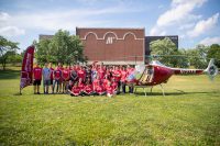 The Governor’s School for Computational Physics students stand near one of Austin Peay State University’s helicopters. (APSU)