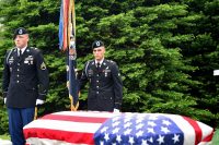 Soldiers assigned to the 101st Airborne Division stand over a casket during the graveside service of Staff Sgt. Al Mampre at Memorial Park Cemetery in Skokie on Saturday, June 15, 2019. Mampre served as a medic with Easy Company, 2nd Battalion, 506th Parachute Infantry Regiment, 101st Airborne Division during World War II. (Sgt. David Lietz)