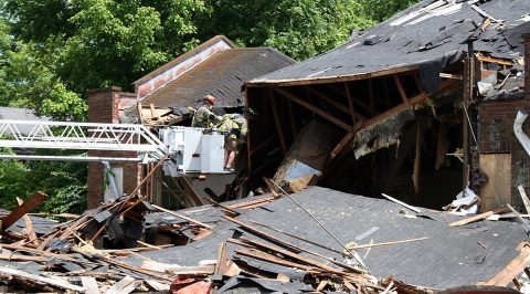 Clarksville Firefighters use a boom truck to extend out over the fallen midsection of the Wesley Chapel during a search operation Thursday. Clarksville Firefighters use a boom truck to extend out over the fallen midsection of the Wesley Chapel during a search operation Thursday.