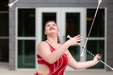 Austin Peay feature twirler Izzy Melbin with three batons. (APSU)