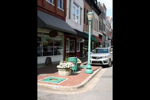 Under a new Franklin Street plan only some of the tree wells will be replanted. In the view above, the tree well to the right, in front of the vehicle, will be replanted, while the one on the left will be covered with a planter. This configuration was designed, in part, to reduce the chance of trees being backed into by motorists while they parallel park along the street.