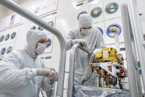 In this image taken June 25th, 2019, engineers install the SuperCam instrument on Mars 2020's rover. This image was taken in the Spacecraft Assembly Facility at NASA's Jet Propulsion Laboratory, Pasadena, California. (NASA/JPL-Caltech)