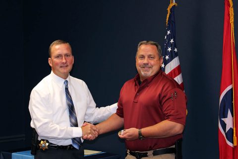 Montgomery County Sheriff John Fuson congratulates Lieutenant Steve Heise.