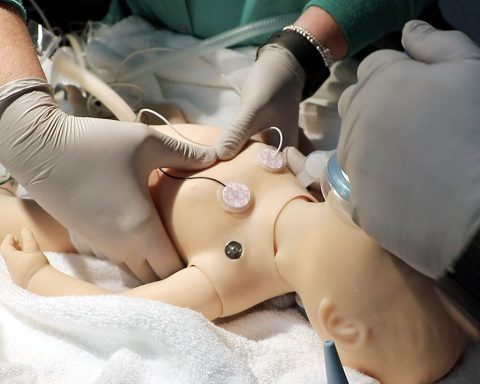 A nursing team practices their neonatal resuscitation technique on a computer controlled newborn simulator during a nursing skills fair at Blanchfield Army Community Hospital. The simulator can measure the nurses' response, measuring compression depth, compression rate, ventilation and other factors, providing valuable feedback and readiness. (Maria Yager)