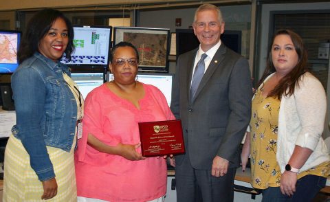 Clarksville Mayor Joe Pitts congratulates members of the Clarksville Police & Fire Dispatch team who helped the department earn Association of Public Safety Communications Officials Certification. Team members, from left, are Angee Daniel, Marla Bonner, and Chaning Jewett.