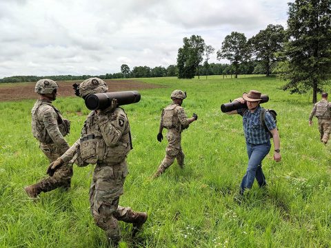 Soldiers from the 101st and Dr. Matthew Yandell, chief innovation officer of HeroWear and recent Vanderbilt graduate, carry howitzer rounds to simulate the physical demands of field artillery missions. (Dr. Karl Zelik, Vanderbilt University)