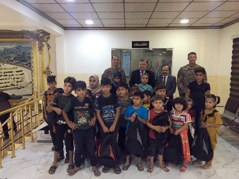 Lt. Col. Trevor Voekel and Command Sgt. Maj. Eddie Brewer of 1st Battalion, 327th Infantry Regiment pose for a photo with local children and the mayor of Mosul in Mosul, Iraq, Sept. 10, 2019. Task Force Ninewah donated 500 backpacks to the Mosul Mayor’s office to distribute to children within the town. The U.S. Soldiers from the 101st Airborne Division are deployed from Fort Campbell, Kentucky. (Maj. Vonnie Wright, 1st Brigade Combat Team, 101st Airborne Division (AA) Public Affairs) Lt. Col. Trevor Voekel and Command Sgt. Maj. Eddie Brewer of 1st Battalion, 327th Infantry Regiment pose for a photo with local children and the mayor of Mosul in Mosul, Iraq, Sept. 10, 2019. Task Force Ninewah donated 500 backpacks to the Mosul Mayor’s office to distribute to children within the town. The U.S. Soldiers from the 101st Airborne Division are deployed from Fort Campbell, Kentucky. (Maj. Vonnie Wright, 1st Brigade Combat Team, 101st Airborne Division (AA) Public Affairs)