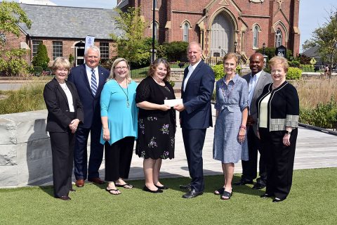 (L-R) Jill Crow (Loaves & Fishes Capital Campaign Chair), Charles D. Keene, Tamara Long (Loaves & Fishes President), Dr. Rita Burnett (Loaves & Fishes Executive Director), Scott Giles (FPC Finance Committee Chair), Vicki Wallace, Issac Wright (Loaves & Fishes Construction Project Manager), and Joyce Norris (FPC Bicentennial Campaign Chair). Scott Giles presents a check for $150,000 to Dr. Rita Burnett. (Gary Norris)