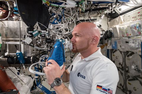 Astronaut Alexander Gerst exhales into an ultra-sensitive gas analyzer for the Airway Monitoring experiment. (NASA)