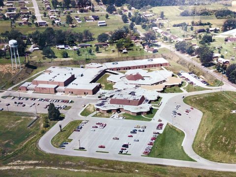 A 1980’s aerial view of Northwest High School (NWHS), in which a gym and classrooms as well as the “400” or “vo-tech” building had been added from the original structure. In 2014, a $17 million renovation was completed which added an auxiliary gym, a theatre, administrative wing, kitchen and indoor corridor to connect the 400 Building. (CMCSS Operations)