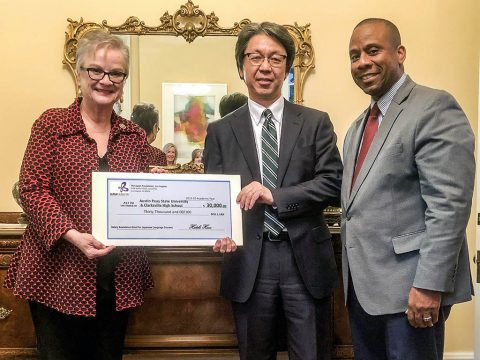 Austin Peay State University President (L) Alisa White and Clarksville-Montgomery County School System Director (R) Millard L. House II is presented a $30,000 check from (Middle) Hiroyuki Kobayashi, Consul-General of Japan.