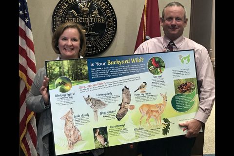 Montgomery County Mayor Jim Durrett and CDE Lightband’s Christy Batts pose with prototype educational panels that will be installed around the exterior of the Wade Bourne Nature Center in Rotary Park.