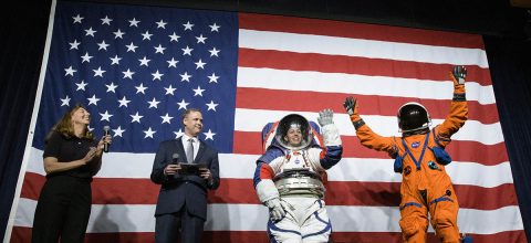 NASA spacesuit engineer Amy Ross and NASA Administrator Jim Bridenstine introduce spacesuit engineer Kristine Davis, wearing a ground prototype of NASA’s new Exploration Extravehicular Mobility Unit (xEMU), and Orion Crew Survival Systems Project Manager Dustin Gohmert, wearing the Orion Crew Survival System suit, Oct. 15, 2019, at NASA Headquarters in Washington. (NASA/Joel Kowsky)