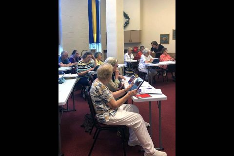 Older adult members of Madison Street United Methodist Church, Clarksville, Tennessee, attend an iPad training session. Money from a Golden Cross Foundation grant helped provide the equipment and training, enabling members to connect electronically with family and friends inside and outside the church.