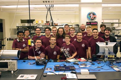 Montana State University students with RadSat-u CubeSat. (NASA) Montana State University students with RadSat-u CubeSat. (NASA)