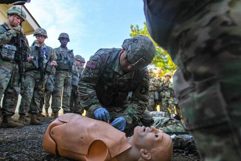 Sgt. Michael Hinkle, medic for 426th Brigade Support Battalion, 1st Brigade Combat Team, 101st Airborne Division (Air Assault), applies a chest seal to the training mannequin, Nov. 18, during a demonstration for Expert Field Medical Badge candidates at Fort Campbell. (Spc. Jeremy Lewis, 40th Public Affairs Detachment) 