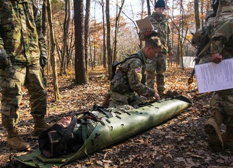 Spc. Matt Waskiewicz, combat medic for 2nd Battalion, 506th Infantry Regiment, 3rd Brigade Combat Team, 101st Airborne Division (Air Assault), secures a casualty for transport in a Skedco litter, Nov. 18, during Expert Field Medic Badge training week. (Spc. Jeremy Lewis, 40th Public Affairs Detachment) 