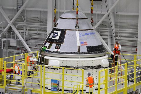 The crew module of Boeing’s CST-100 Starliner spacecraft is lifted onto its service module on Oct. 16 inside the Commercial Crew and Cargo Processing Facility (C3PF) at Kennedy Space Center in Florida ahead of the company’s Orbital Flight Test to the International Space Station as part of NASA’s Commercial Crew Program. (Boeing)