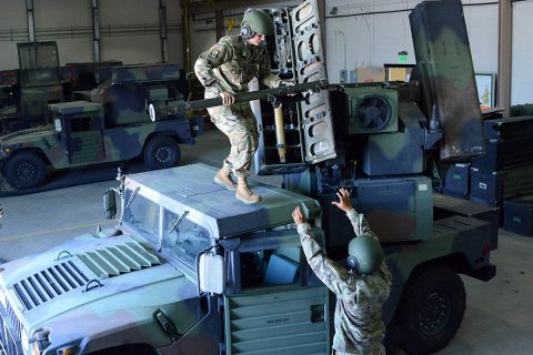 Sgt. 1st Class Arianna Cook offloads a Stinger Missile from an Avenger pod so that it can be fired off the shoulder as a Man-Portable Air Defense System. MANPADS is used under degraded conditions if the Avenger cannot fire due to a cyber attack or electronic warfare. (Gary Sheftick) 