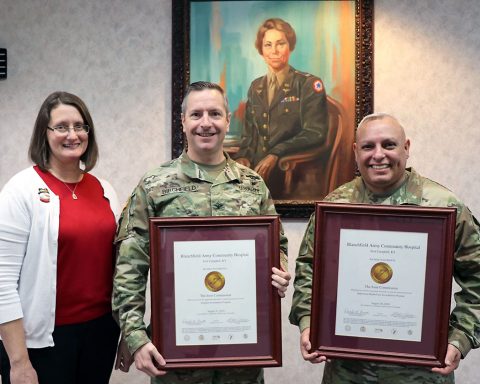 BACH Accreditation Manager, Ms. Quetta Beck, Hospital Commander, Col. Patrick T. Birchfield, and Hospital Command Sergeant Major, Command Sgt. Maj. Daniel Santiago, proudly display the hospital's Gold Seals of Approval from The Joint Commission. The Joint Commission accredits and certifies more than 22,000 health care organizations and programs in the United States.  (U.S. Army photo by Maria Yager)