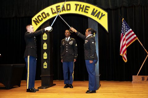 BACH Sgt. DeMarcus Heath prepares to step through the arch of the Noncommissioned Officer, formally joining the ranks of the Army's NCO Corps, during an NCO Induction ceremony on Fort Campbell, Kentucky, January 24. BACH held a combined Sergeant Audie Murphy Club and NCO Induction Ceremony celebrate the history and significance of the corps, known as the back bone of the Army, and to formally welcome its newest sergeants. (US Army photo by David Gillespie)