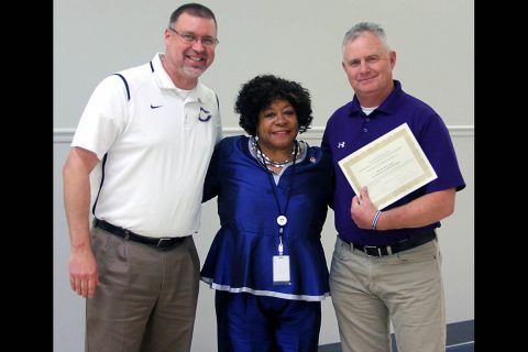 Clarksville High School principal Bryan Feldman stands with School Board member Carol Berry and Coach Brian Hetland.