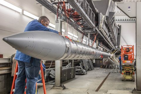 Wallops electrical technician Frank Waters preparing the C-REX-2 payload for transport back to the Assembly Area. This is a rare photo of a Black Brant XII completely staged on the launcher. Usually, the Andoya Space Center crew installs the environmental protection enclosure (seen long the wall) as each stage is loaded on the rail. (NASA/Terry Zaperach) Wallops electrical technician Frank Waters preparing the C-REX-2 payload for transport back to the Assembly Area. This is a rare photo of a Black Brant XII completely staged on the launcher. Usually, the Andoya Space Center crew installs the environmental protection enclosure (seen long the wall) as each stage is loaded on the rail. (NASA/Terry Zaperach)