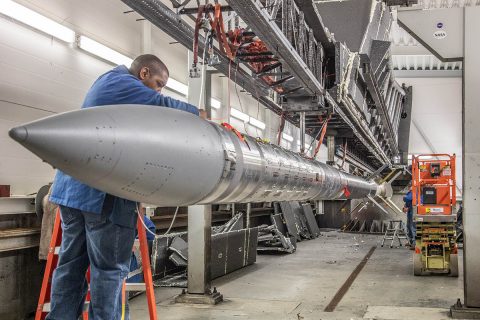 Wallops electrical technician Frank Waters preparing the C-REX-2 payload for transport back to the Assembly Area. This is a rare photo of a Black Brant XII completely staged on the launcher. Usually, the Andoya Space Center crew installs the environmental protection enclosure (seen long the wall) as each stage is loaded on the rail. (NASA/Terry Zaperach)