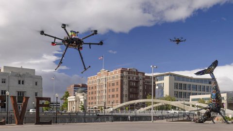 Drones in flight in downtown Reno, Nevada, during shakedown tests for NASA's Unmanned Aircraft Systems Traffic Management project, or UTM. The final phase of flight tests, known as Technical Capability Level 4, took place from May through August 2019 and studied how the UTM system could integrate drones into urban areas. (NASA/Dominic Hart)