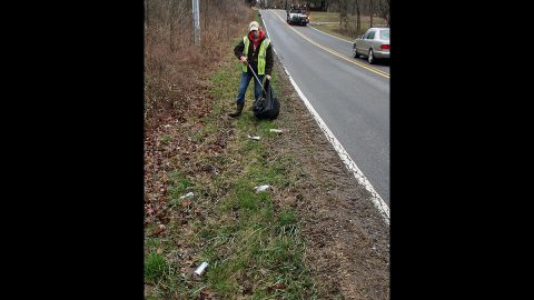 Litter Fighter: Clarksville Street Department worker Brennan Hudson picks up bottles, cans and trash along Dunbar Cave Road on Thursday.