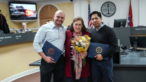 Ingeborg Johnson is flanked by Flumencio Brinkley and Sergio Carrillo, who were honored for bravely removing Johnson from a wrecked vehicle just as it burst into flames. The three gathered for a happy reunion at Thursday’s City Council meeting.