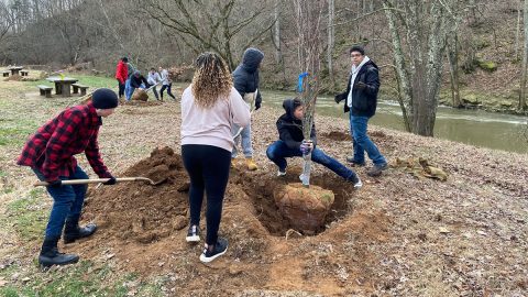 Northeast High ROTC Students volunteer to plant trees along riverbank at Billy Dunlop.