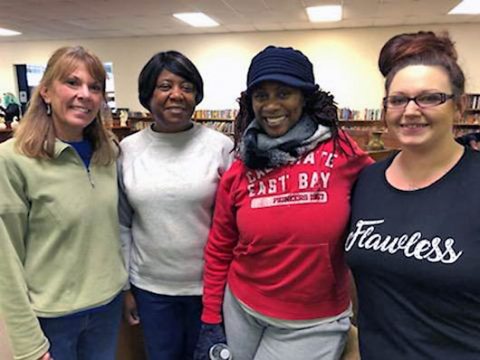 Volunteers and future homeowners work together in the Clarksville ReStore to improve the working space. 