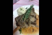 Lamb shank braised on the stove top, seasoned with salt and pepper, then slow-roasted for four hours with veal stock, honey, onion and thyme. Topped with a sprig of rosemary