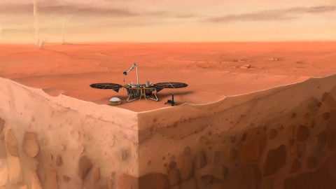 In this artist's concept of NASA's InSight lander on Mars, layers of the planet's subsurface can be seen below and dust devils can be seen in the background. (IPGP/Nicolas Sarter)