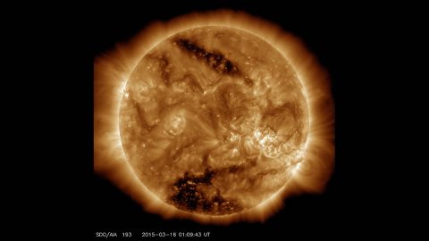 This image from NASA’s Solar Dynamics Observatory on March 16, 2015, shows two dark spots, called coronal holes. The lower coronal hole, a polar coronal hole, was one of the biggest observed in decades. (NASA/SDO)