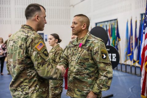 Command Sgt. Maj. Gabelmann, senior enlisted advisor, 1st Brigade Combat Team, 101st Airborne Division (Air Assault) is awarded the Legion of Merit March 3, in an award ceremony held before a change of responsibility ceremony in Sabo Physical Fitness Center on Fort Campbell, Ky. Gabelmann received the award in recognition of his outstanding leadership of 1st BCT over the last 30 months. (U.S. Army photo by Sgt. James Griffin) 