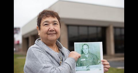 Wilma Newton holds a picture of her father in front of the upcoming military family resource. (APSU)