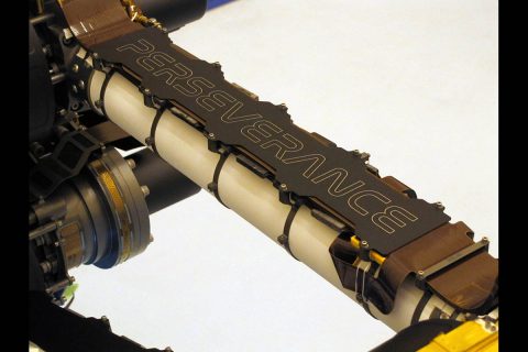 This image of the nameplate secured to the arm of NASA's Mars Perseverance rover was taken at a payload servicing facility at Kennedy Space Center soon after being attached on March 4, 2020. The laser-etched plate serves as a rock and debris shield that will protect a flexible electrical cable. (NASA/JPL-Caltech) This image of the nameplate secured to the arm of NASA's Mars Perseverance rover was taken at a payload servicing facility at Kennedy Space Center soon after being attached on March 4, 2020. The laser-etched plate serves as a rock and debris shield that will protect a flexible electrical cable. (NASA/JPL-Caltech)