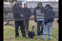 NASA researchers survey the crashed drone. A safety crash net was assembled to help save the vehicle from extensive damage. (NASA)