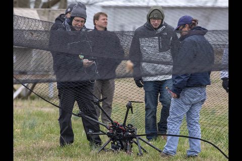 NASA researchers survey the crashed drone. A safety crash net was assembled to help save the vehicle from extensive damage. (NASA) NASA researchers survey the crashed drone. A safety crash net was assembled to help save the vehicle from extensive damage. (NASA)