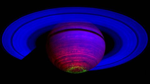 This false-color composite image shows auroras (depicted in green) above the cloud tops of Saturn's south pole. The 65 observations used here were captured by Cassini's visual and infrared mapping spectrometer on Nov. 1, 2008. (NASA/JPL/ASI/University of Arizona/University of Leicester)