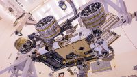 The Mars Helicopter, visible in lower center of the image, was attached to the belly of NASA’s Perseverance rover at Kennedy Space Center on April 6, 2020. The helicopter will be deployed onto the Martian surface about two-and-a-half months after Perseverance lands. (NASA/JPL-Caltech)