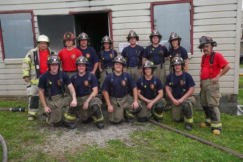 Clarksville Fire Rescue’s new firefighters with training staff during Thursday’s live-fire exercise.