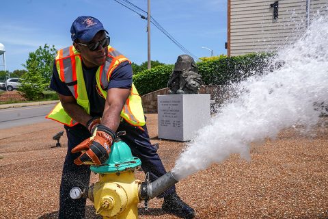 A Clarksville Fire Rescue firefighter flushes a fire hydrant near Fire Station 1.