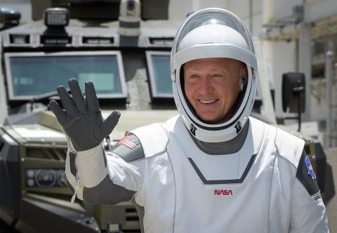 NASA astronaut Douglas Hurley waves as he and fellow crew member Robert Behnken depart the Neil A. Armstrong Operations and Checkout Building for Launch Complex 39A to board the SpaceX Crew Dragon spacecraft for the Demo-2 mission launch, Saturday, May 30, 2020, at NASA’s Kennedy Space Center in Florida. (NASA/Bill Ingalls)